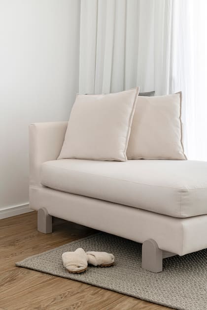 Sillón estilo chaise longue y almohadones (Malé) confeccionado con género de Tienda Mayor. Alfombra (Rugit).