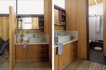 Sobre la mesada, toalla de lino (Materia), pequeña maceta con planta (Otra Sudestada), cepillo y peine de madera (The Body Shop). En el sector más privado del baño, piso de granito negro y azulejos blancos (San Lorenzo).
