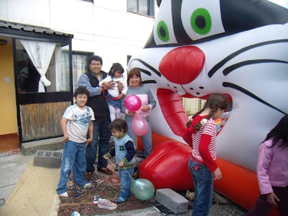 Sofía en los brazos de sus padres y junto a varios amiguitos durante los festejos por su cumpleaños de 3.