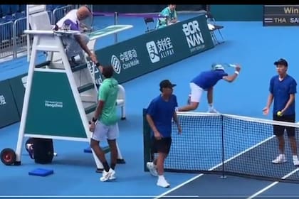 Soon-Woo Kwon destroza su raqueta contra el suelo mientras su rival y vencedor, el tailandés Kasidit Smarej, saluda al juez del partido.