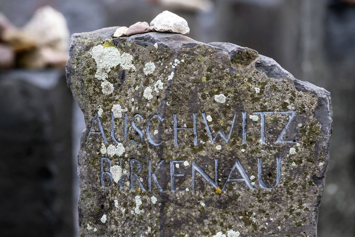 Stones lie on a Auschwitz-Birkenau memorial stone on occasion of the international Holocaust remembrance day in the former Nazi concentration camp Buchenwald near Weimar, Germany, Friday, Jan. 26, 2018. (AP Photo/Jens Meyer)