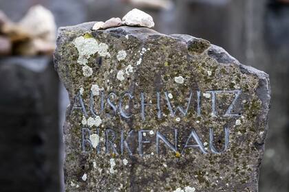 Stones lie on a Auschwitz-Birkenau memorial stone on occasion of the international Holocaust remembrance day in the former Nazi concentration camp Buchenwald near Weimar, Germany, Friday, Jan. 26, 2018. (AP Photo/Jens Meyer)
