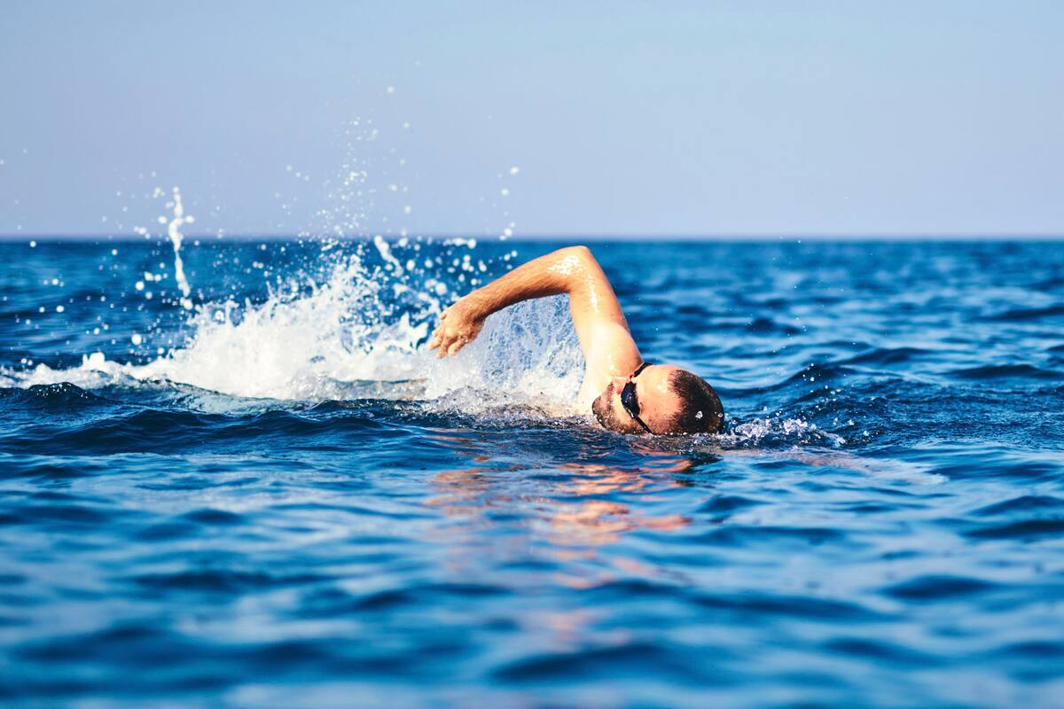 Swimmer training on the open sea / ocean.