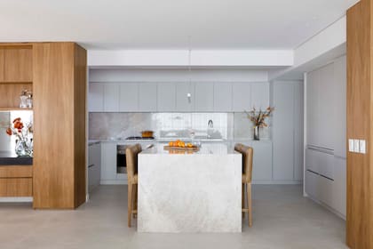 Tanto la mesada como la isla son de cuarcita ‘Taj Mahal’. Mueble de cocina laqueado. Todos los tomacorrientes se escondieron en la base de la alacena.