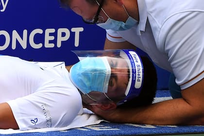 Tapabocas y máscara durante la atención del fisioterapeuta a Novak Djokovic en Nueva York durante una pausa en la semifinal que el serbio le ganaría a Roberto Bautista Agut.