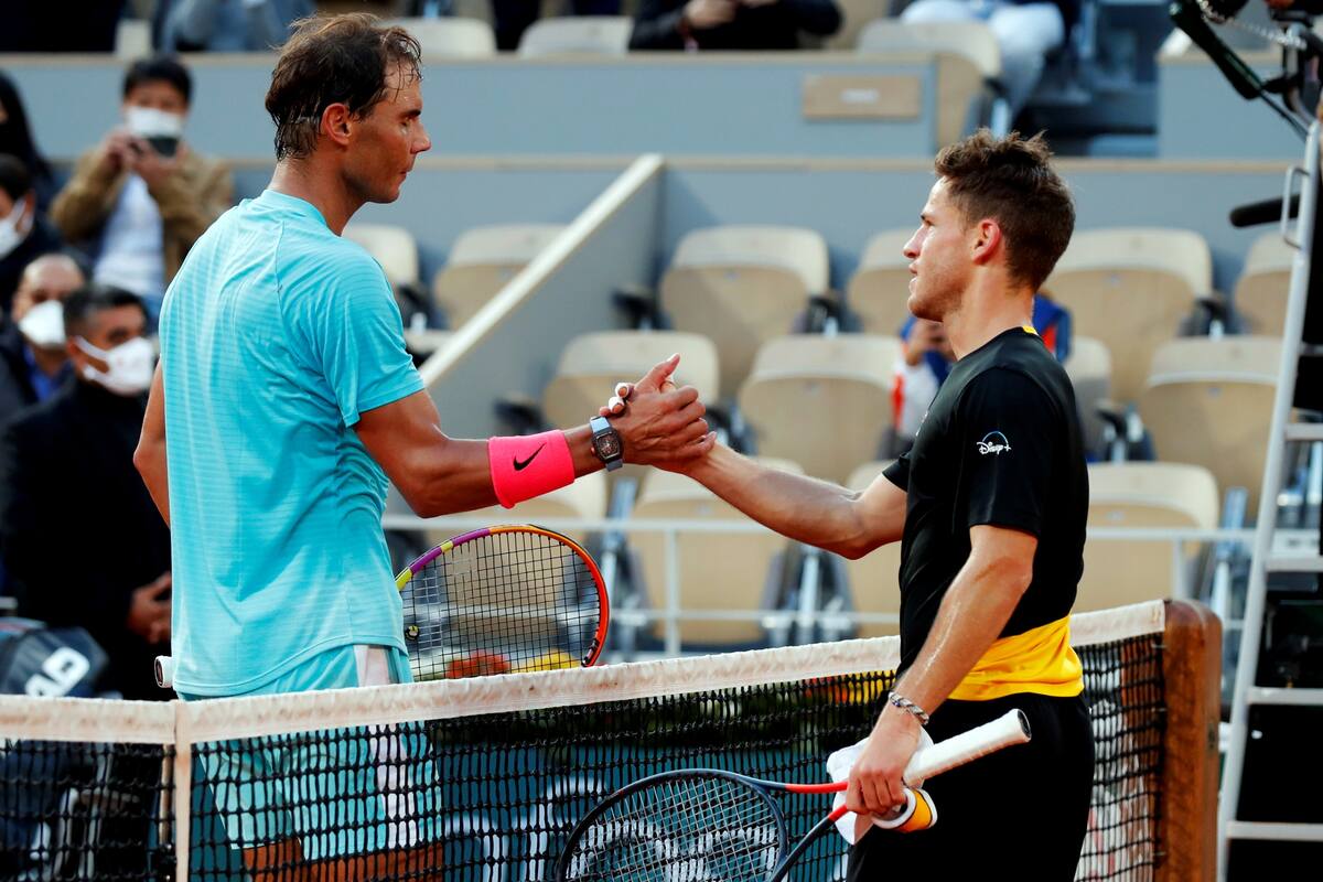 Tennis - French Open - Roland Garros, Paris, France - October 9, 2020 Spains Rafael Nadal shakes hands with Argentinas Diego Schwartzman after winning the semi final match