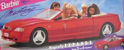 These Barbies drive a Ford Mustang.