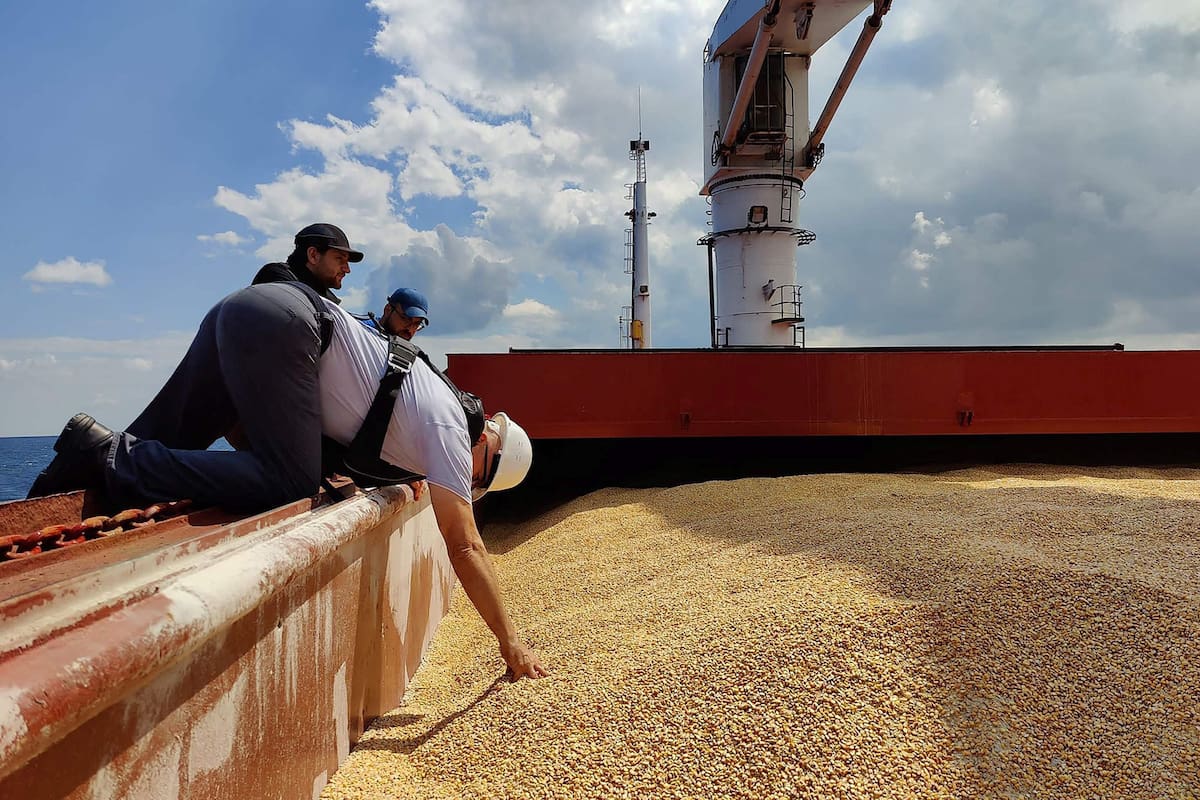 This handout picture taken and released by the Turkish Defence ministry press office on August 3, 2022, shows an inspection delegation member inspecting the Sierra Leone-flagged cargo ship Razoni carrying 26,000 tonnes of corn from Ukraine, off the coast of north-west Istanbul. - A team of Russian and Ukrainian officials in Turkey is due on August 3, 2022, to inspect the first shipment of grain exported from Ukraine since Moscow's invasion under a deal aimed at curbing a global food crisis. The Sierra Leone-flagged Razoni arrived at the edge of the Bosphorus Strait just north of Istanbul on Tuesday, a day after leaving the Black Sea port of Odessa carrying 26,000 tonnes of maize bound for Lebanon. (Photo by Turkish Defence Ministry / TURKISH DEFENCE MINISTRY / AFP) / RESTRICTED TO EDITORIAL USE - MANDATORY CREDIT "AFP PHOTO / TURKISH DEFENCE MINISTRY PRESS OFFICE" - NO MARKETING - NO ADVERTISING CAMPAIGNS - DISTRIBUTED AS A SERVICE TO CLIENTS