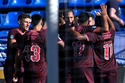 Todos abrazan a Carlos Izquierdoz, autor del gol de cabeza de Lanús para ganar en la cancha de Vélez, por el torneo Apertura