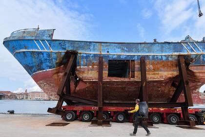 TOPSHOT - The fishing vessel "Barca Nostra" (Our Ship) that sank on April 18, 2015 trapping hundreds of migrants in its hull, is being installed in Venices former shipyards as part of the centerpiece of a new art project by Swiss-Icelandic artist Christoph Buechel, prior to the the 58th In