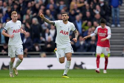 Tottenham's Cristian Romero celebrates after scoring his side's first goal during the English Premier League soccer match between Tottenham Hotspur and Arsenal at the Tottenham Hotspur Stadium in London, England, Sunday, April 28, 2024. (AP Photo/Kin Cheung)
