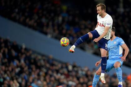 Tottenham's Harry Kane kicks the ball during the English Premier League soccer match between Manchester City and Tottenham Hotspur, at the Etihad stadium in Manchester, England, Saturday, Feb. 19, 2022. (AP Photo/Jon Super)