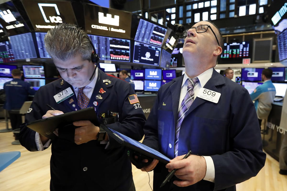 Traders John Panin, left, and David Fox work on the floor of the New York Stock Exchange, Tuesday, Jan. 28, 2020. U.S. stocks rose in early trading Tuesday as investors shifted money into technology companies following a broad sell-off a day earlier over fears that the spread of a deadly virus in Ch