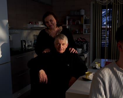 Tuomo Puutio, a retired farmer, and his daughter, Marjukka, an orchestra manager, in Lohtaja, Finland on Feb. 23, 2023. In Finland, “you get the chance to be a cello player, even if you are a farmer’s daughter,” Marjukka said. (Jake Michaels/The New York Times)