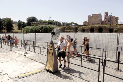 Turistas buscan refrescarse cerca del Coliseo de Roma, en medio de la ola de calor que azota a Italia. (Alessandro Penso/The New York Times)