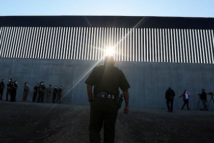 Un agente de la Patrulla Fronteriza de Estados Unidos camina hacia una nueva sección del muro fronterizo antes de la llegada del secretario interino de Seguridad Nacional, Chad Wolf, el jueves 29 de octubre de 2020, en McAllen, Texas. (Joel Martinez/The Monitor vía AP)