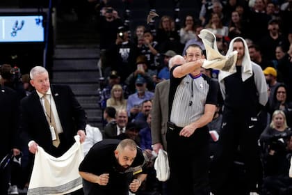 Un árbitro intenta espantar a un murciélago con una toalla, en la casa de los Spurs