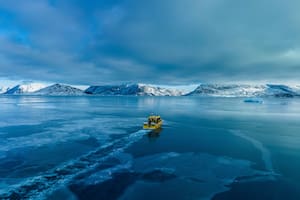 Un bote navega a través de una entrada de mar congelado en las afueras de Nuuk, Groenlandia, el 6 de marzo de 2025
