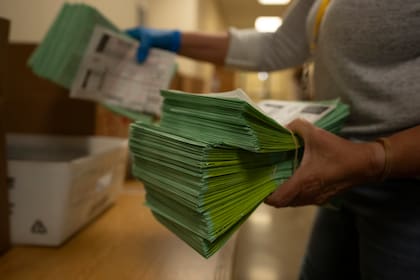 Un funcionario electoral envía papeletas por correo en el Centro Electoral y de Tabulación del condado de Maricopa, en Phoenix, Arizona, el martes 5 de marzo de 2024. (AP Foto/Serkan Gurbuz)