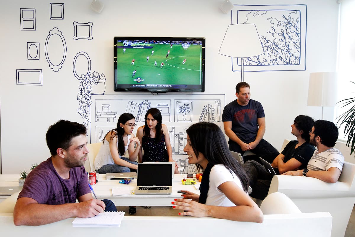 Un grupo de empleados en una habitual reunión de trabajo en un living de la oficina
