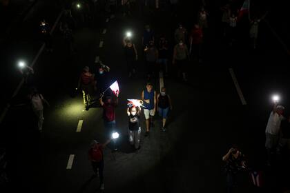 Un grupo de personas marcha por la Avenida Las Ámericas para protestar contra la compañía eléctrica LUMA por los recientes apagones, el viernes 15 de octubre de 2021, en San Juan, Puerto Rico. (AP Foto/Carlos Giusti)