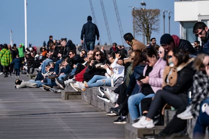 Un grupo de personas se reúne en el puerto de Malmo, en Suecia, para tomar sol a pesar de las recomendaciones del gobierno de practicar el distanciamiento social