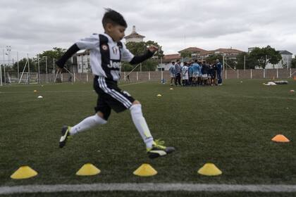 Un joven jugador entrena en el predio Tita Mattiusi de Racing. El club de Avellaneda elabora estrategias que emulan los costosos equipos utilizados por equipos europeos con desarrollos tecnológicos locales