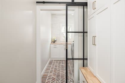 Un lavadero al que se accede por una puerta corrediza de vidrio que conecta con la cocina