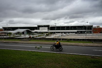 Un motociclista circula frente al aeropuerto internacional Eduardo Gomes, en Manaos