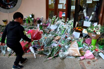 Un niño acude con flores a la escuela del profesor asesinado