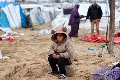Un palestino observa mientras sus familiares reorganizan su carpa, un día después de que el ejército israelí bombardeara un campamento de tiendas que alojaba a familias desplazadas, en el campo de refugiados de Al-Shati, en Ciudad de Gaza