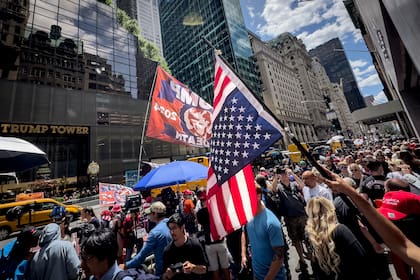 Un partidario del expresidente Trump ondea una bandera invertida durante una manifestación frente a la Torre Trump