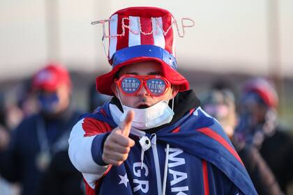 Un partidario del presidente Donald Trump llega para un mitin en víspera de las elecciones el 2 de noviembre de 2020 en Grand Rapids, Michigan