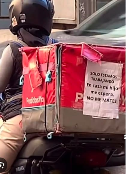 Un repartidor con un cartel dirigido a los ladrones de motos