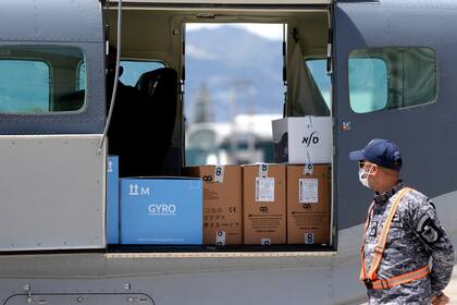 Un soldado mira cajas que contienen 5000 dosis de la vacuna Moderna contra el Covid-19 donadas por Israel a su llegada a la base de la Fuerza Aérea, en la Ciudad de Guatemala el 25 de febrero de 2021