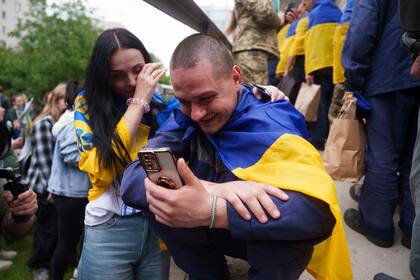 Un soldado ucraniano habla por teléfono con un familiar tras volver del cautiverio en un intercambio de prisioneros de guerra entre Rusia y Ucrania, en la región de Chernyhiv, Ucrania, el sábado 24 de mayo de 2025.