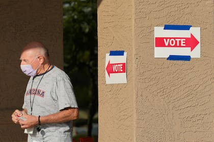 Un trabajador del distrito electoral sale de una casilla de votación durante las primarias estatales, el martes 30 de julio de 2024, en Sun City West, Arizona. (AP Foto/Ross D. Franklin)