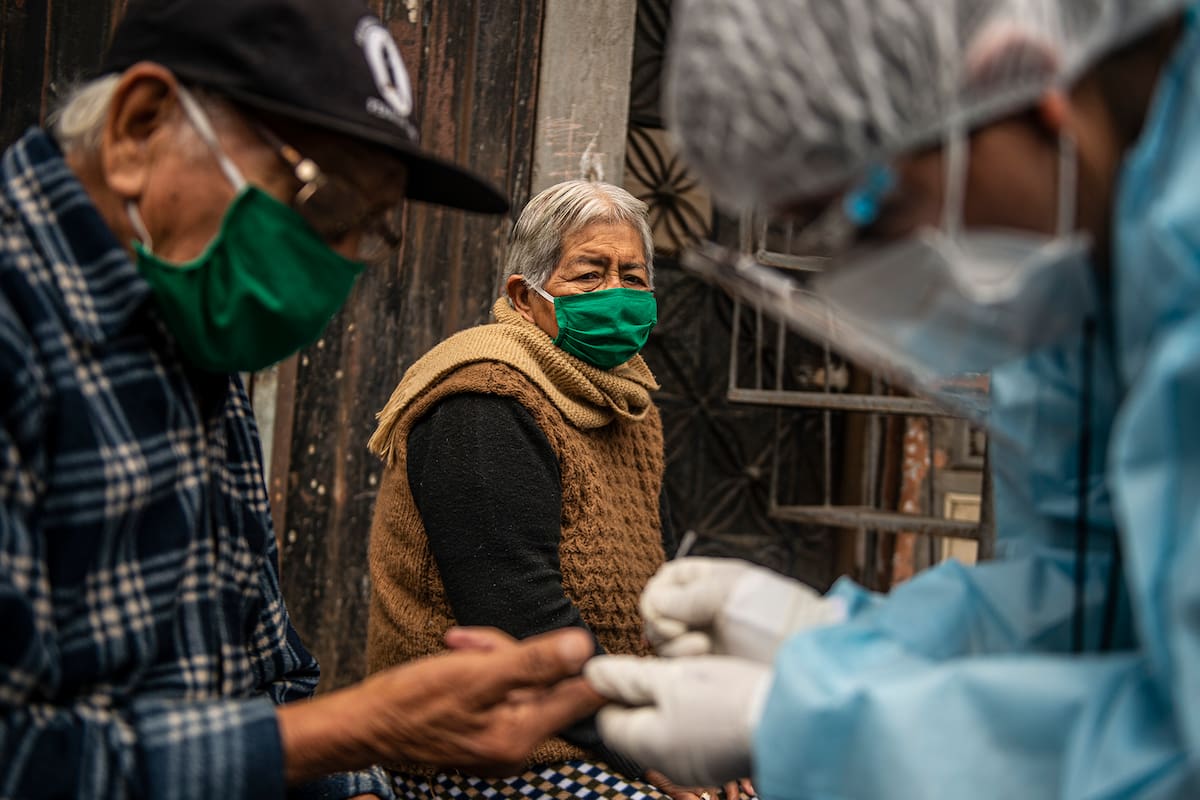 Un trabajador del Ministerio de Salud peruano examina y realiza una prueba para descartar la Covid-19 en pacientes mayores de 60 años en sus casas en el barrio Perales, distrito de Santa Anita, al este de Lima el 20 de agosto de 2020