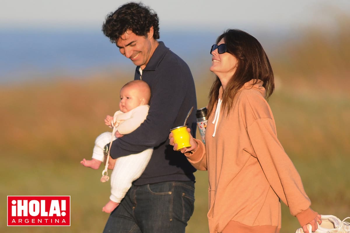 Una imagen de absoluta felicidad: Isabel Macedo, descalza, y con el mate en la mano, vuelve de la playa junto a su marido y sus hijas.