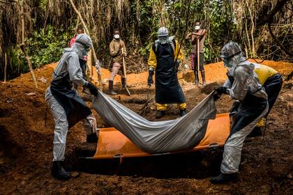 Una imagen que se ha vuelto cotidiana en algunos países de África: el entierro de una víctima de ébola, en Liberia
