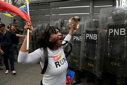 Una manifestante desafía a las fuerzas de seguridad durante la marcha en Caracas