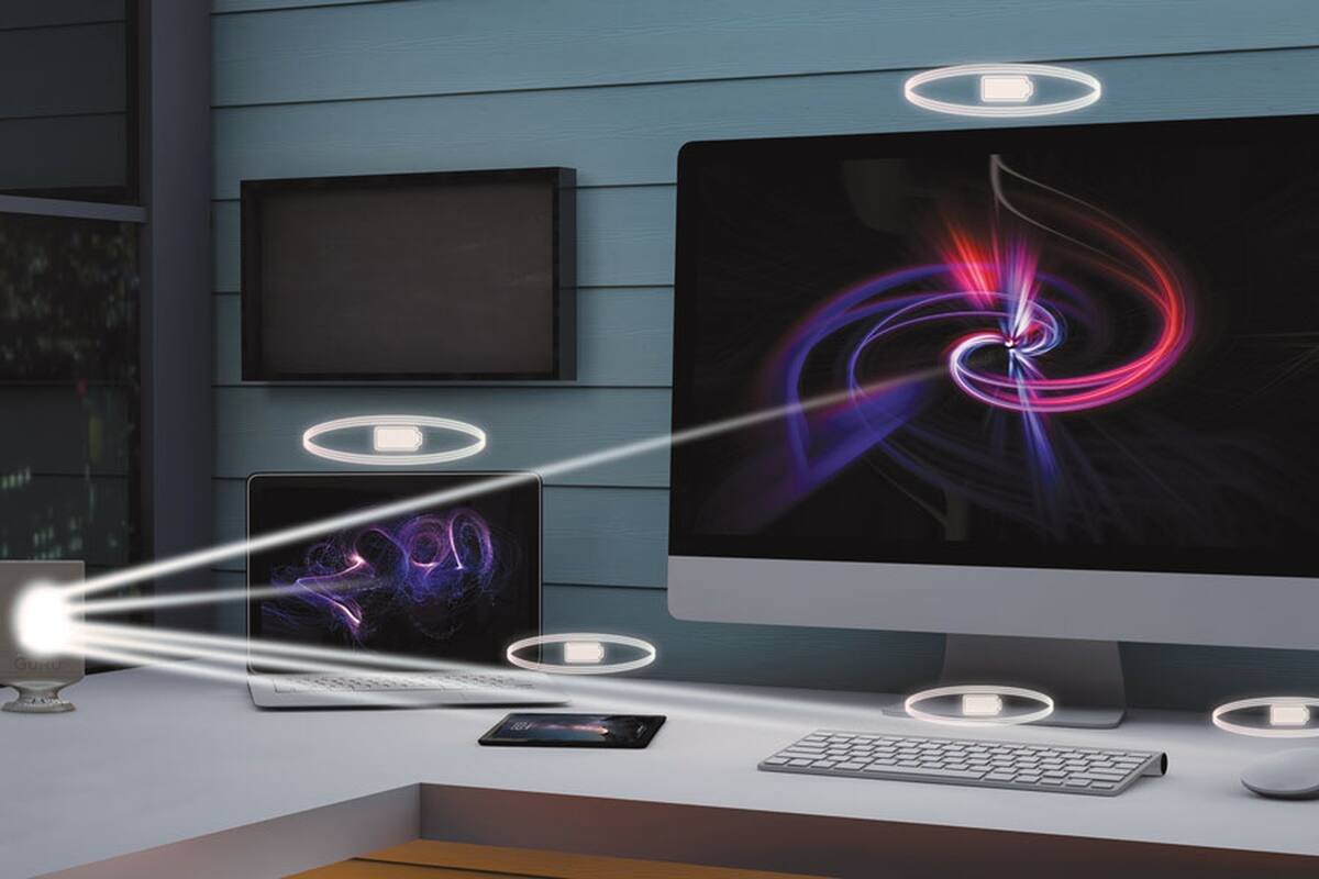 Una simulación de cómo una antena de GuRu podría darle energía por el aire a varios dispositivos en simultáneo