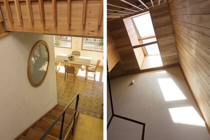 Una ventana circular con vidrio esmerilado deja pasar luz natural al baño. La escalera de cedro con baranda metálica está iluminada por una claraboya.