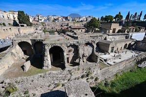 Una vista del Parque Arqueológico Herculano, con la figura del vocán Vesubio al fondo