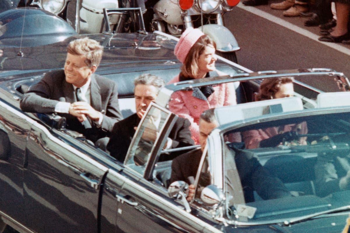 US President John F Kennedy, First Lady Jacqueline Kennedy, Texas Governor John Connally, and others smile at the crowds lining their motorcade route in Dallas, Texas, on November 22, 1963. Minutes later the President was assassinated as his car passed through Dealey Plaza.