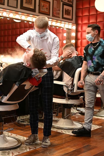 Varios jóvenes se cortan el cabello en "Barber Barber Barbers" en Liverpool, Inglaterra
