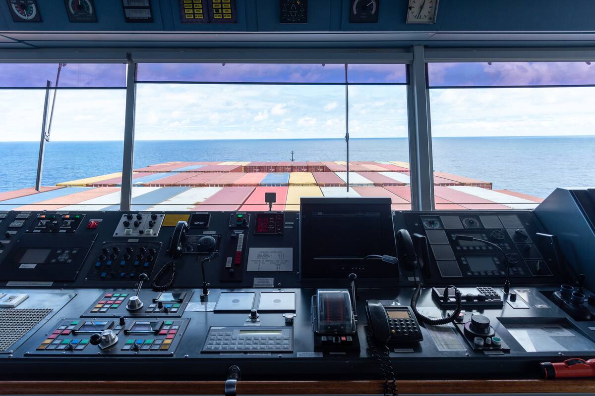 View of the control console on the navigational bridge of the cargo container ship.