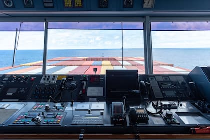 View of the control console on the navigational bridge of the cargo container ship.