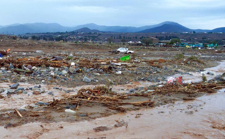 View of the outlet of a river in a rural area of Coquimbo region, Chile, on July 21, 2026, following severe weather conditions. Heavy rains in Chile have killed at least 13 people and left more than 60,000 others cut off due to washed out roads, government officials said in a report on July 21, 2026, as the recovery effort focused on restoring basic services. (Photo by Armando Gonzalez / AFP)