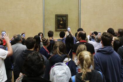 Visitantes ante la "Mona lisa" en el Louvre en París; tomar fotos con el celular, en vez de ver la pintura, se ha convertido en la experiencia principal